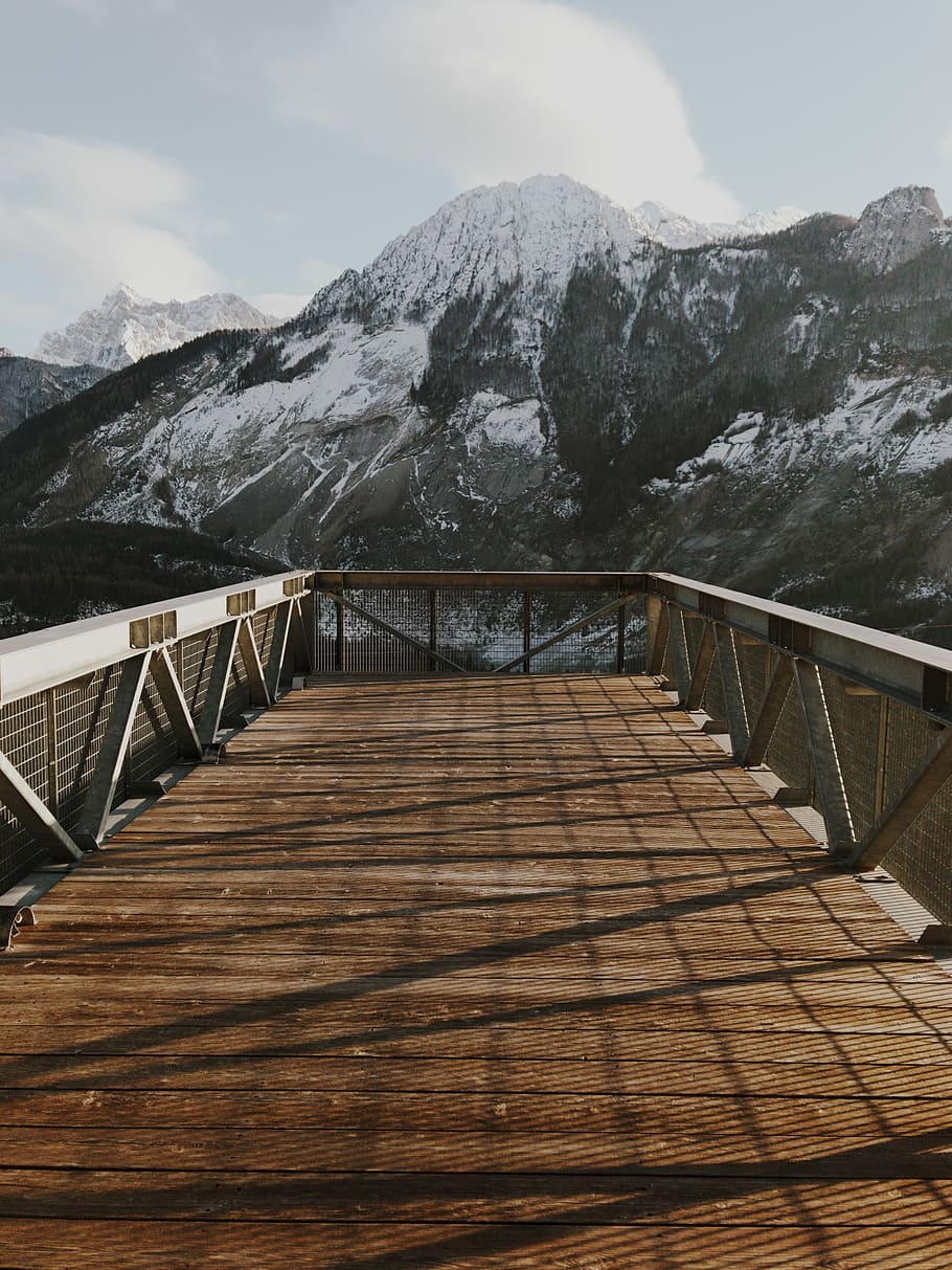 photo of snow covered mountain under cloudy blue sky, brown wooden balcony HD wallpaper
