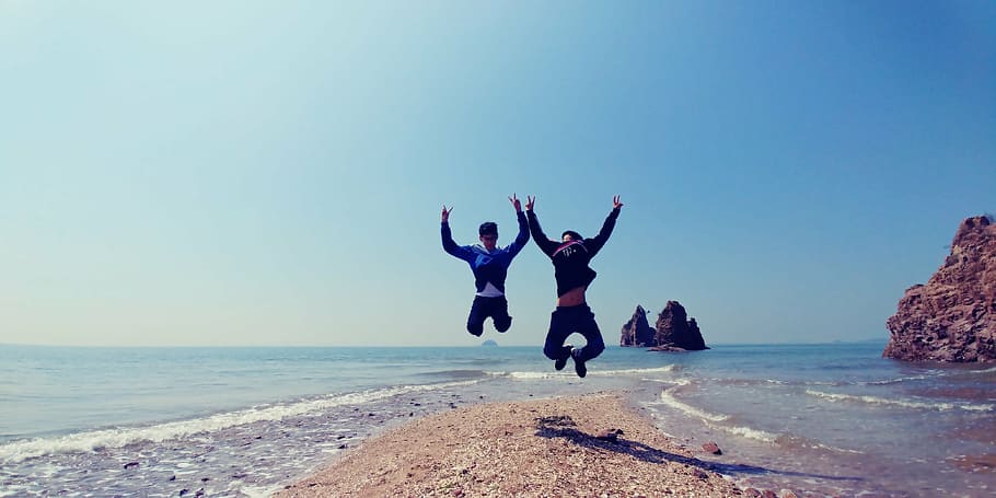 men jumping near body of water, jebudo, play, waves, blue, sea HD wallpaper