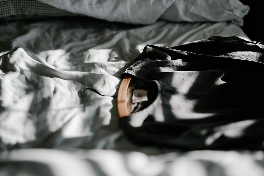 Linen dress on hanger, black scoop-neck top on white textile HD wallpaper