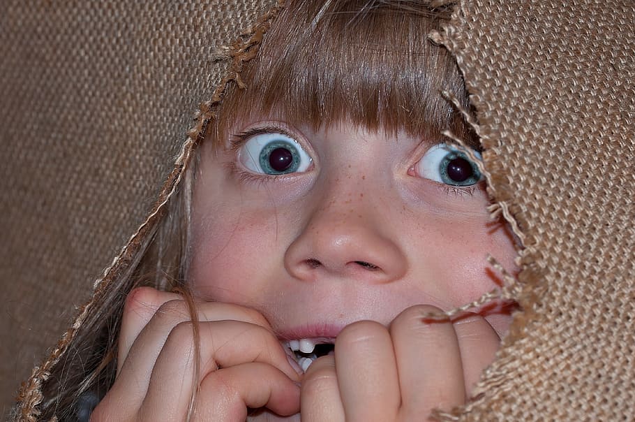 girl hiding on brown textile, person, human, child, eyes, face