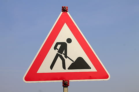 man working ahead road signage, shield, marking, site, construction site sign HD wallpaper