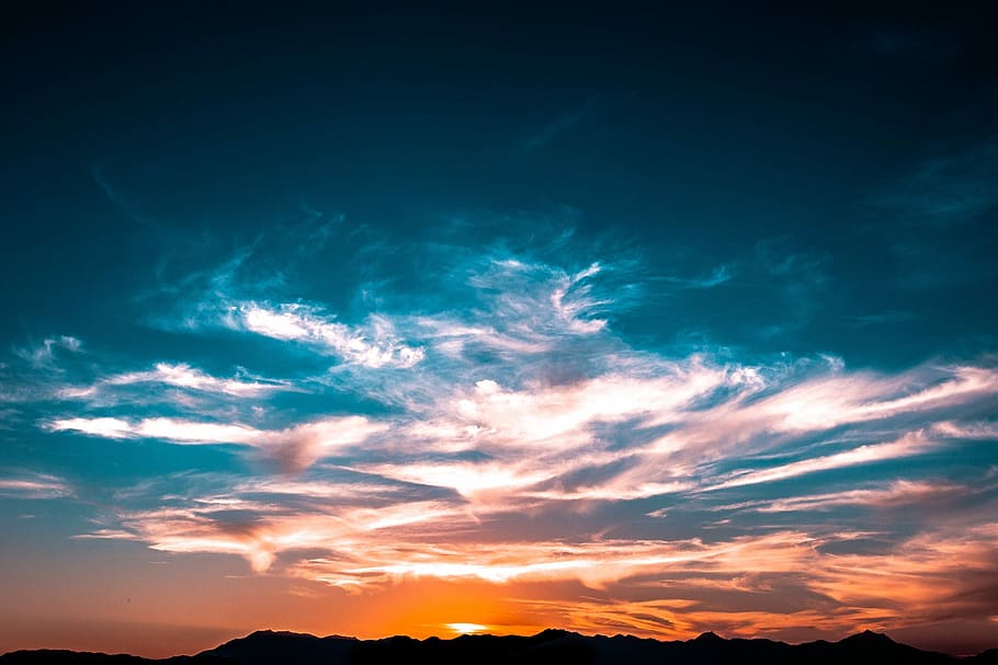 mountains under cloudy skies during golden hour, mountain under orange sunset HD wallpaper