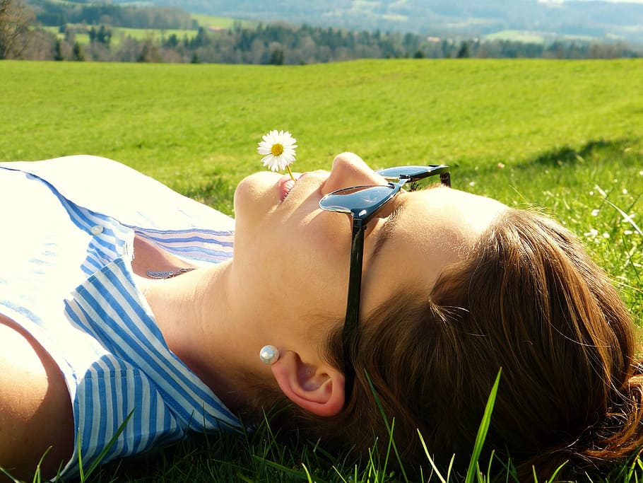 woman wearing sunglasses lying on grass, young woman, meadow