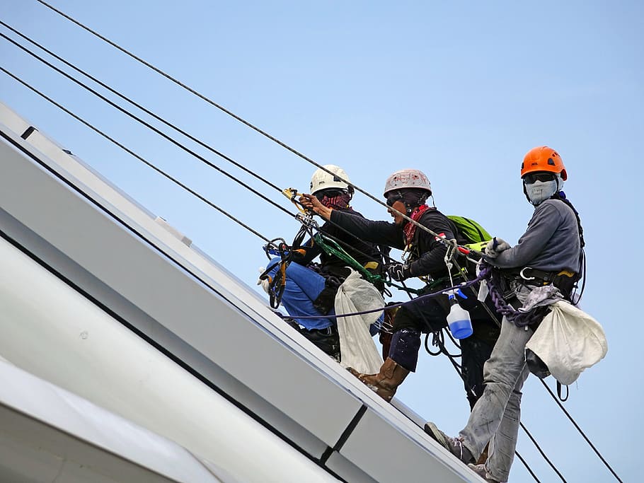 three men rapelling on white steel roof, rappelling, rope, safety