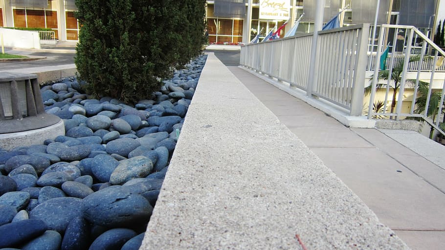 rocks, pebbles, sidewalk, cement, stones, architecture, height HD wallpaper
