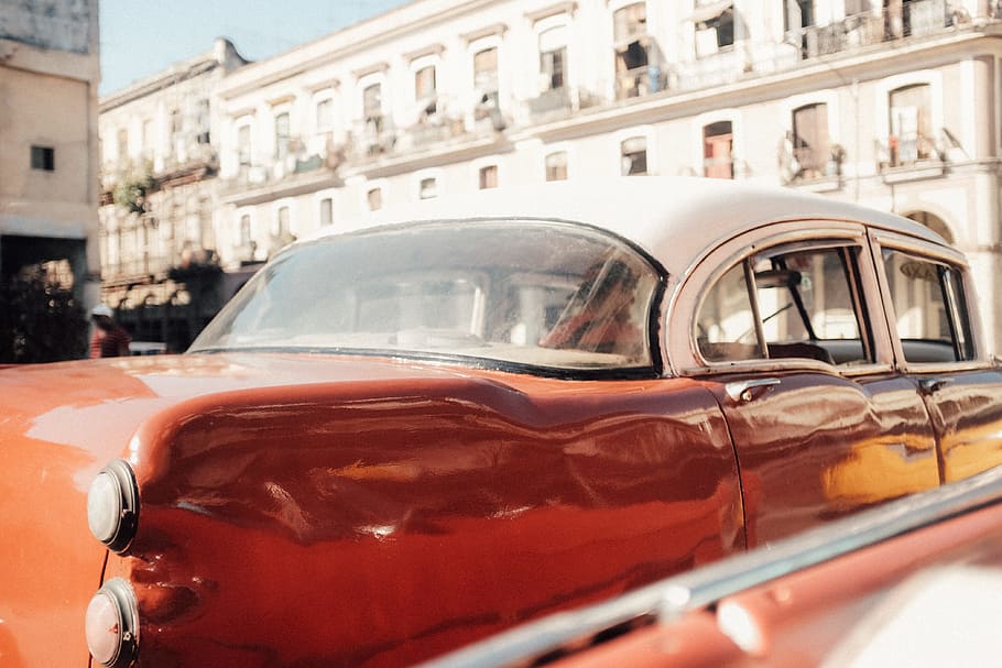 close up photography of red and white sedan, red and white convertible coupe during daytime photography HD wallpaper