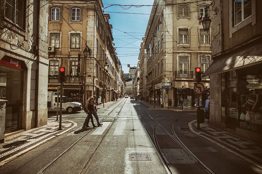 Street shot showing the red lights at a traffic signal in Lisbon, Portugal HD wallpaper