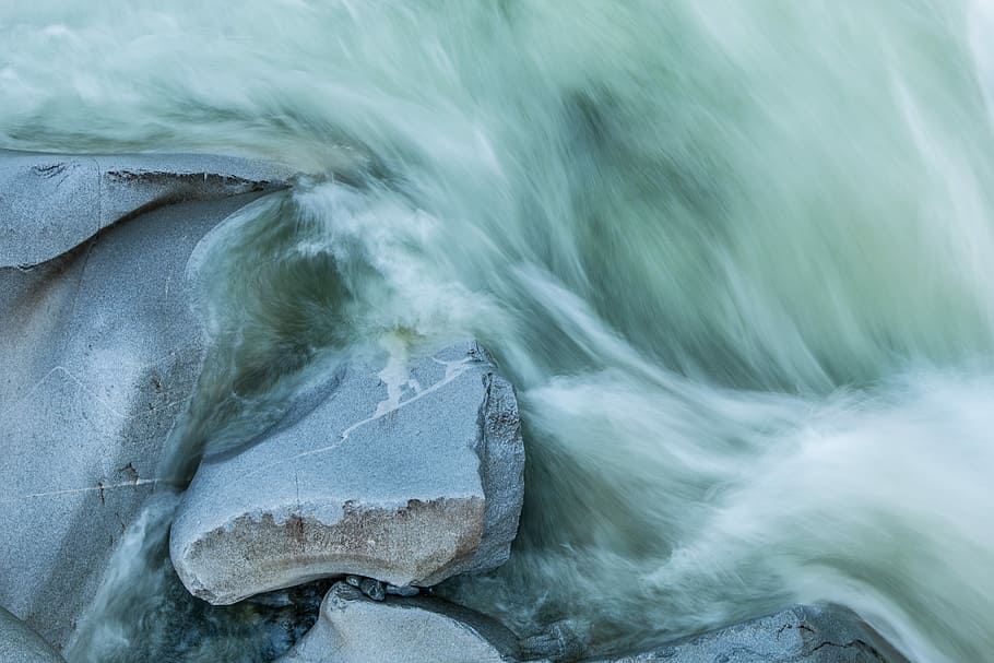 time-lapse photography of rock fragment and body of water, gray rock beside body of water HD wallpaper