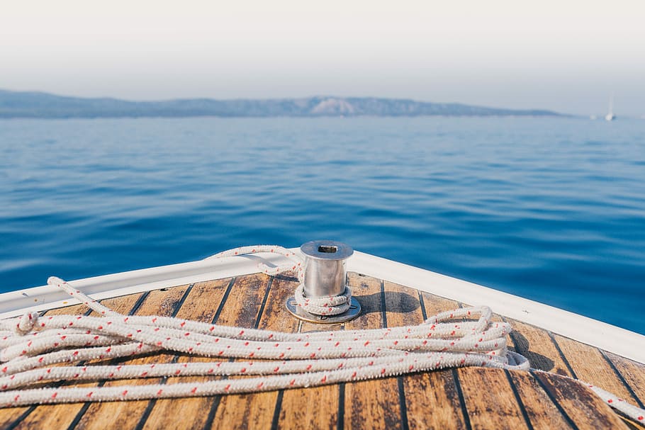 shallow focus photography of road on boat, boat in sea during daytime HD wallpaper