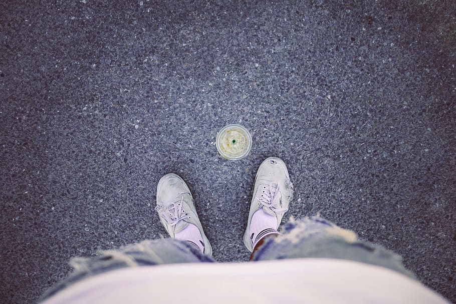 person wearing white low-top shoes, person standing in front of drainage HD wallpaper