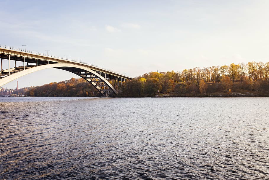 low angle photo of gray metal bridge during daytime, sea, water HD wallpaper