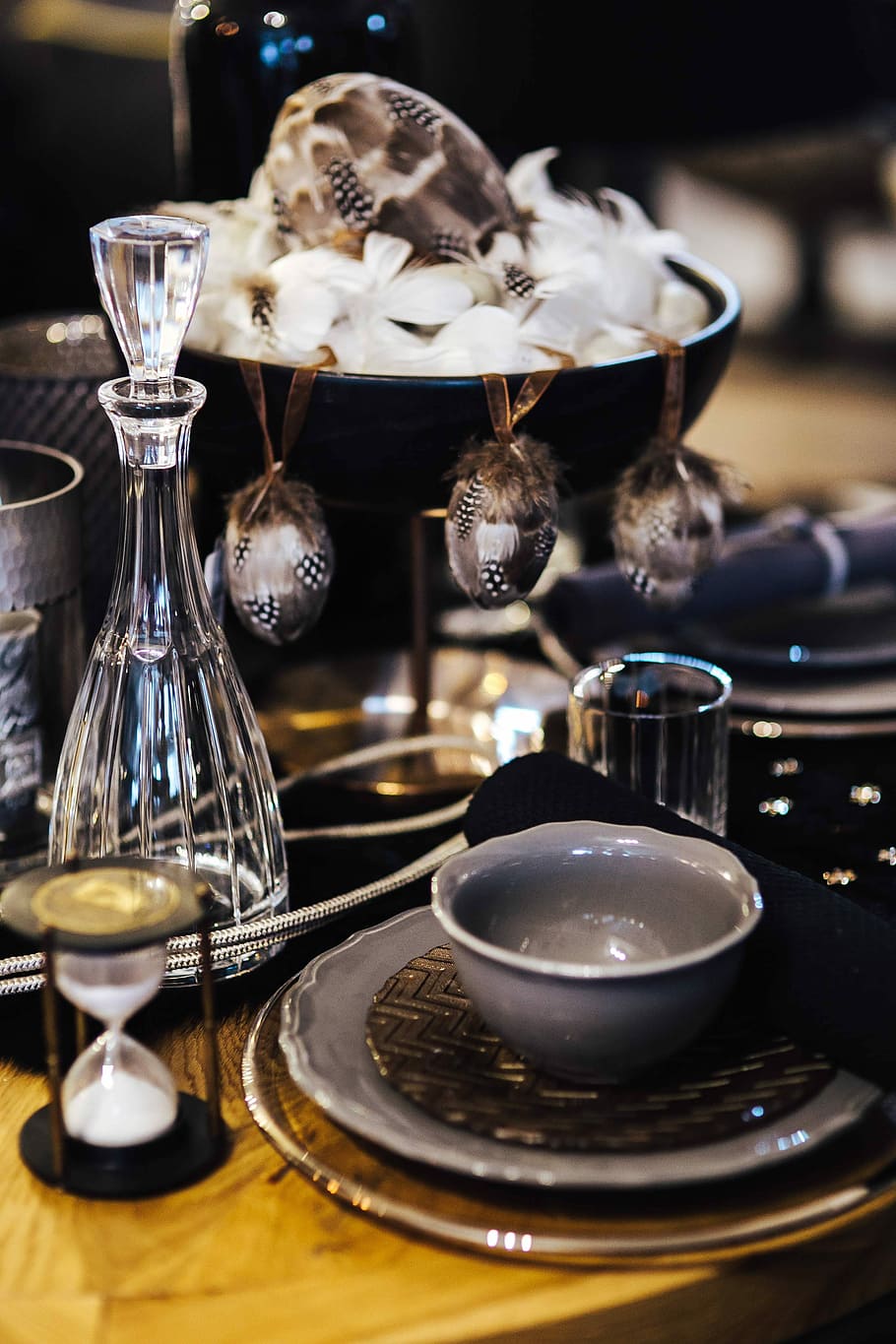 Fancy restaurant dinner table decorated with quail eggs and feathers HD wallpaper
