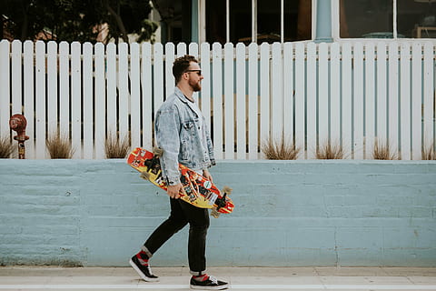 man walking near fence carrying skateboard, people, guy, alone HD wallpaper