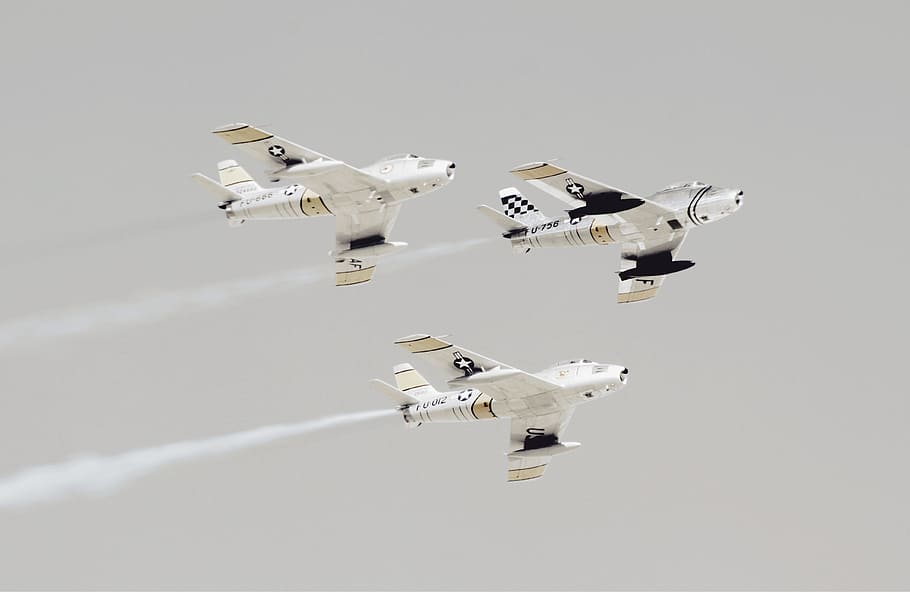 three white-and-black jet planes, three planes flying in the sky