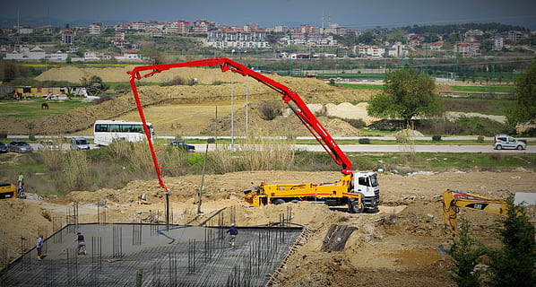 red and yellow mobile crane on field, concrete, bottom plate HD wallpaper