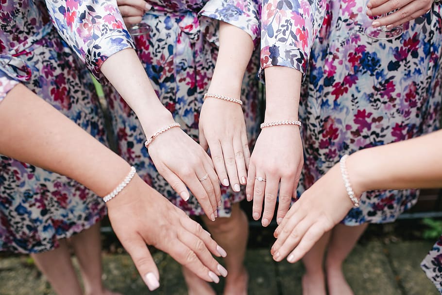 four women putting their hands together at the center, women showing their hands HD wallpaper