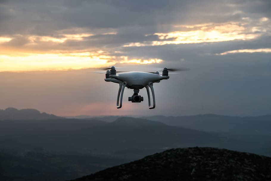 white DJI quadcopter drone flying in mid-air, white qaudcopter drone hovering in the air HD wallpaper