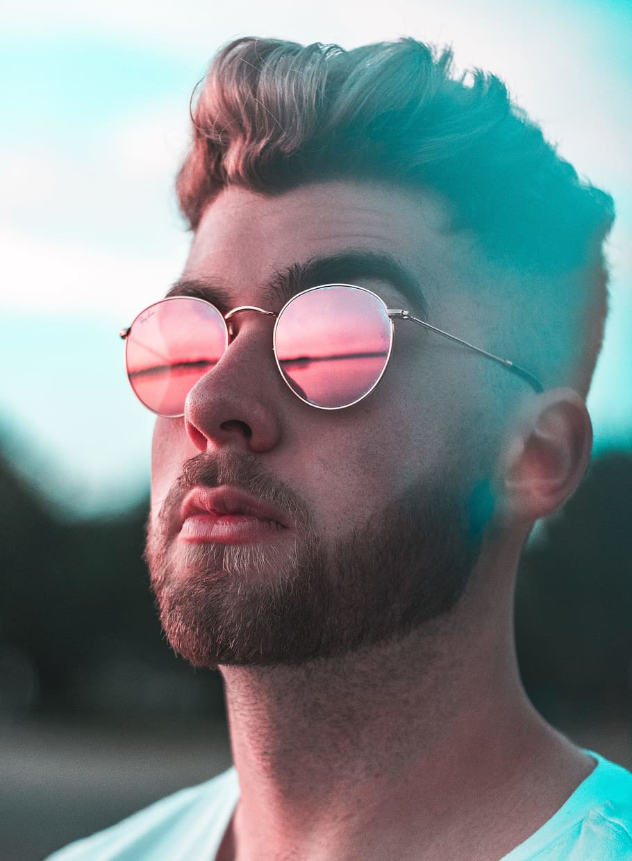 close-up photography of man wearing red lens sunglasses, Red vs. Blue
