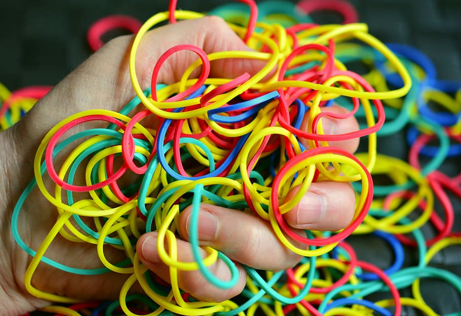 person holding assorted-colored loombands, Rubber, Rings, Hand