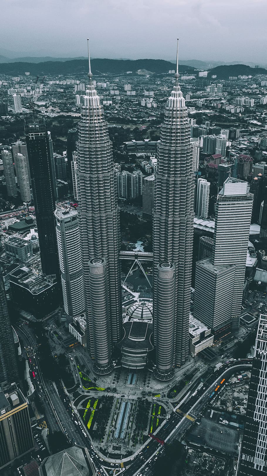 aerial view of gray twin tower concrete buildings under gray sky, Petronas Tower Malaysia HD wallpaper
