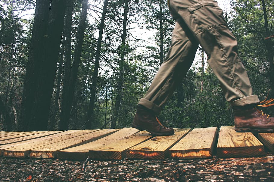 person walking on brown wooden floor, man, pants, shoes, boots HD wallpaper
