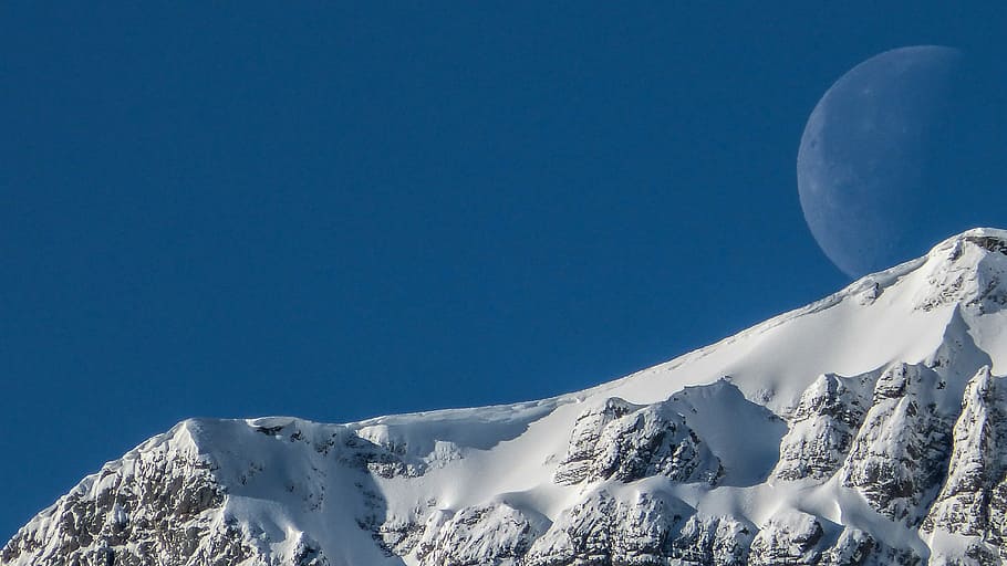 photo of full moon during daytime and ice coated mountain, snow-capped mountain slope under full moon HD wallpaper