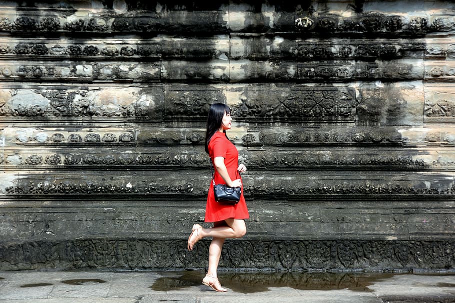 woman standing beside wall, wearing, red, min, dress, black, leather