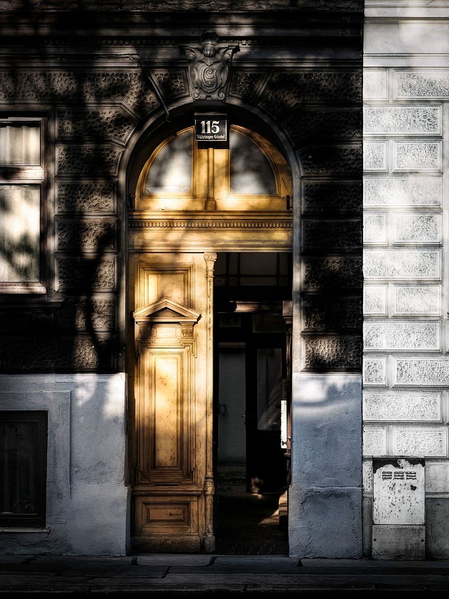 opened brown wooden door, gray concrete building with brown wooden door HD wallpaper