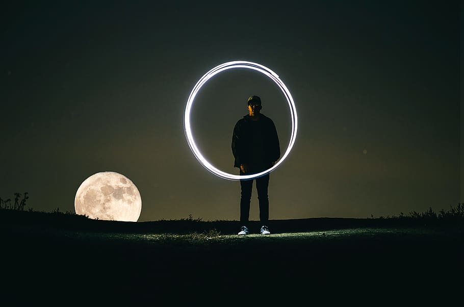 man standing on hill during full moon, man standing under full moon