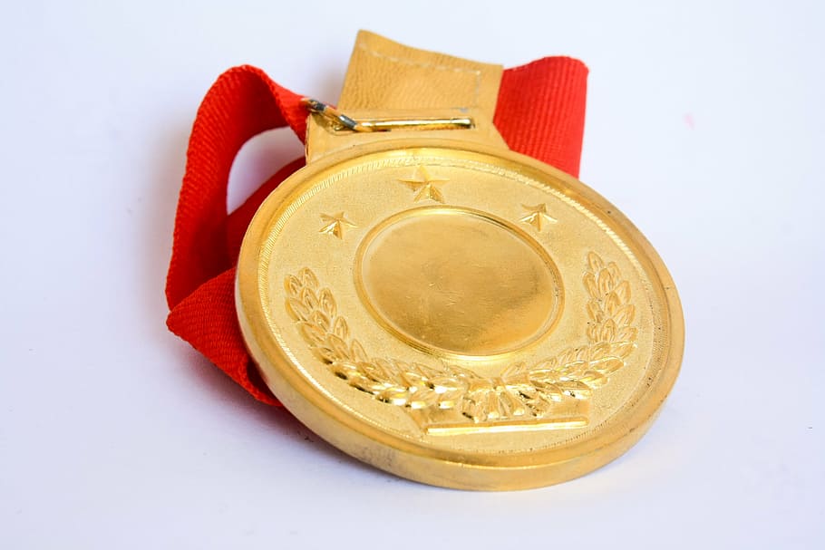 gold medal on white surface, award, success, achievement, winner