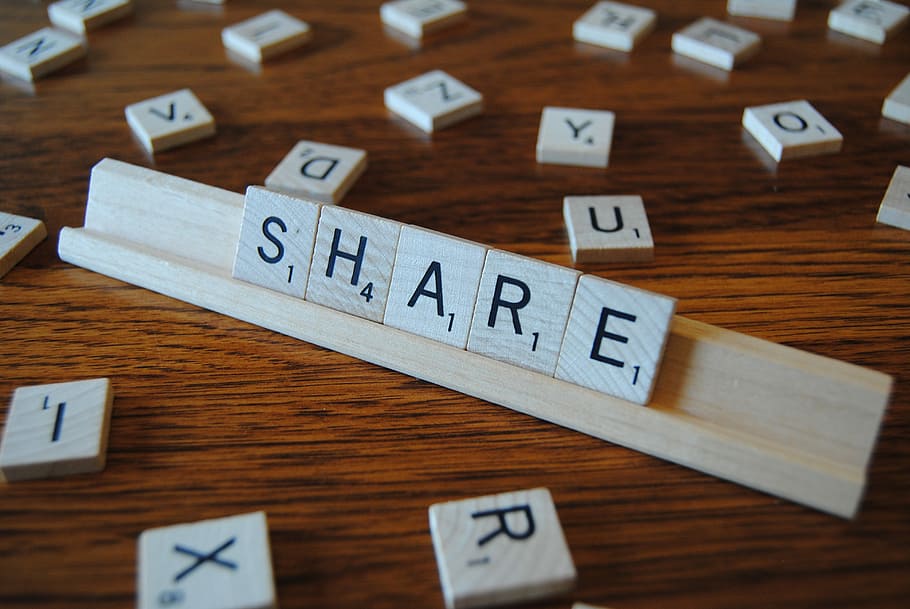 brown scrabble with S.H.A.R.E. letter display on brown wood surface HD wallpaper
