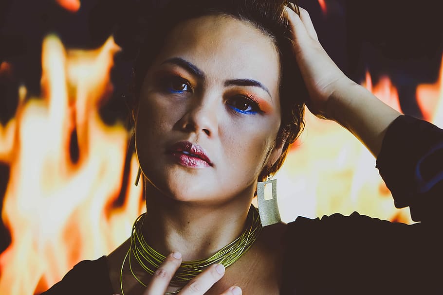 Fire Element, woman wearing black top and gold necklace, make up