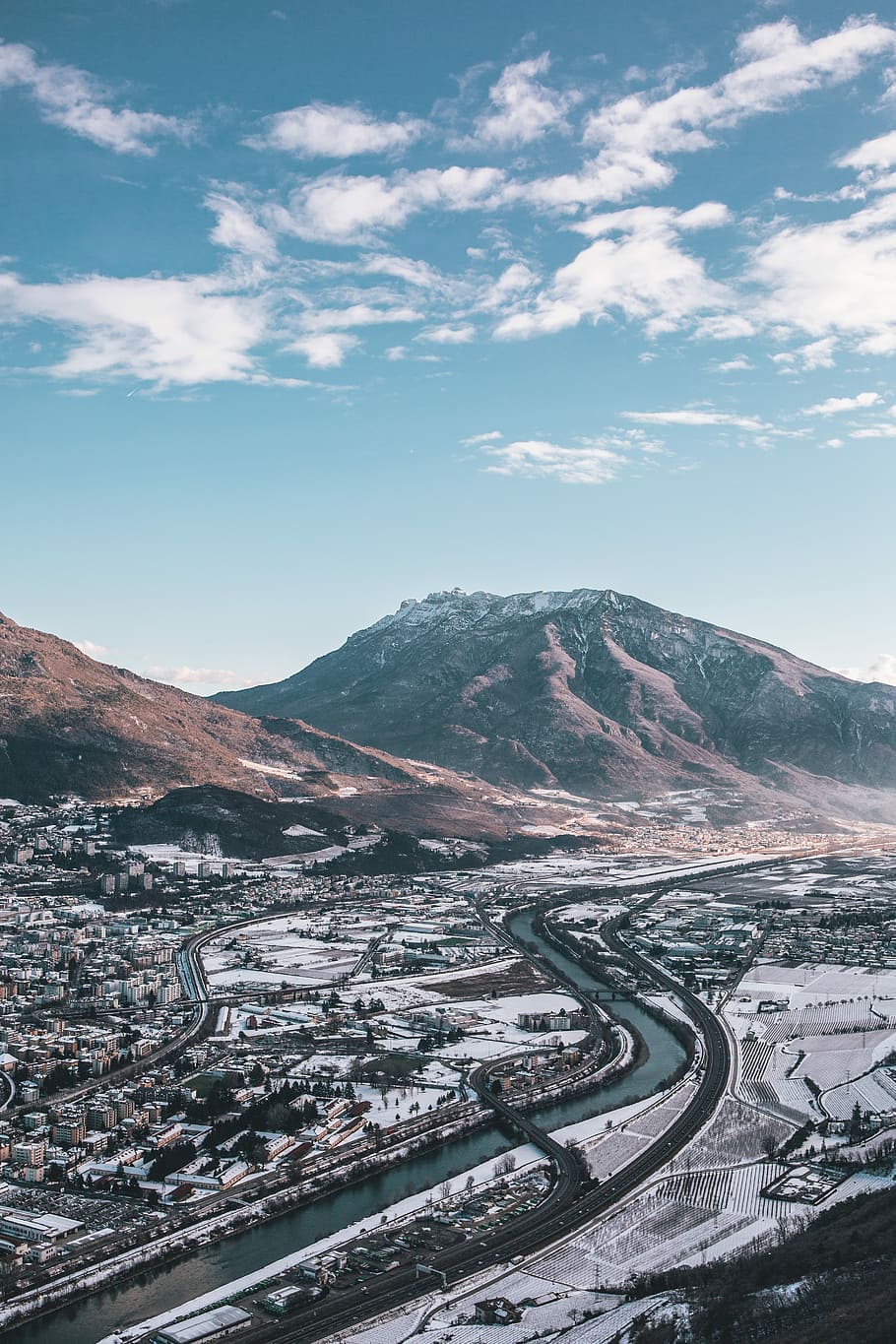aerial view photography of body of water near mountain at daytime, body of water in between road near city HD wallpaper