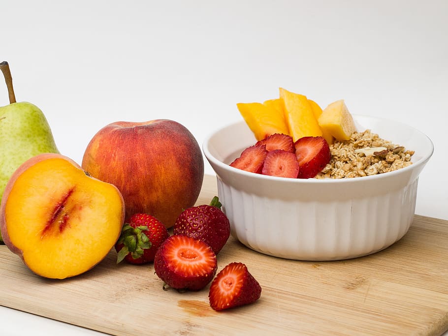 assorted fruits beside white ceramic bowl, peach, pear, strawberry