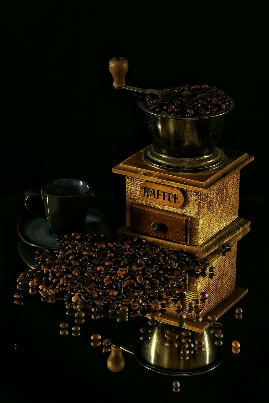 coffee beans beside black ceramic teacup and vintage manual coffee brewer HD wallpaper
