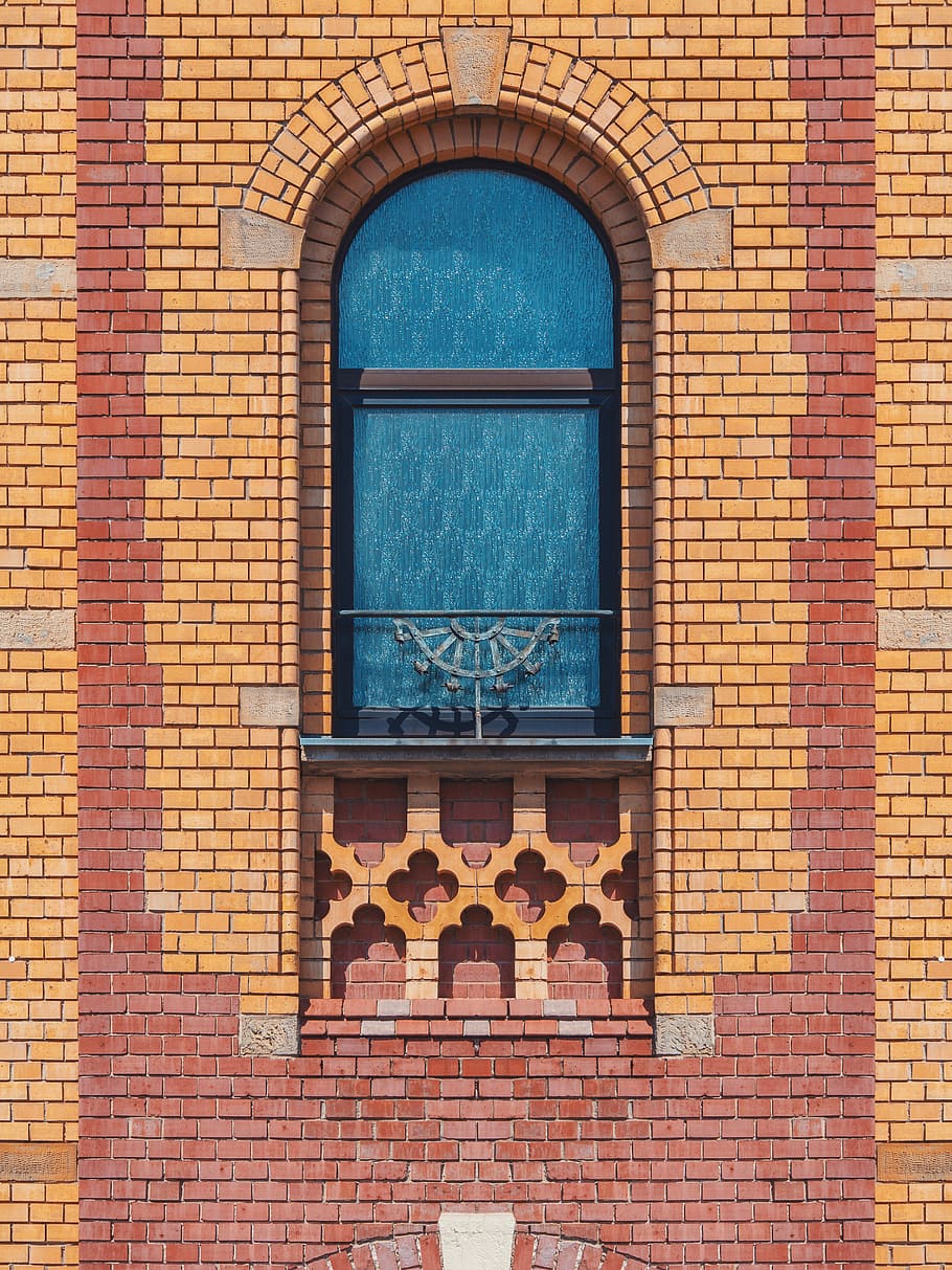 red and yellow painted building, closed black and gray glass window HD wallpaper