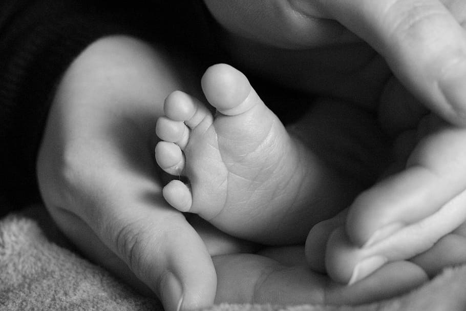 person holding baby's feet, foot, blackwhite, birth, hand, woman