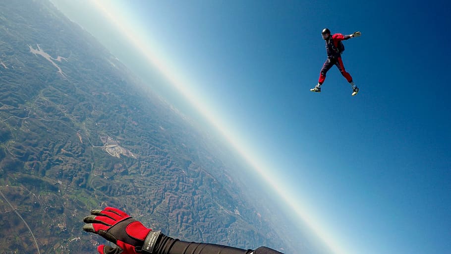Skydive in Algarve, two person sky diving under blue sky, sky dive