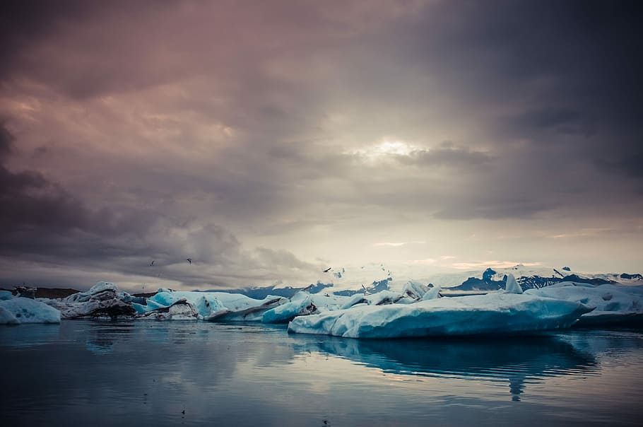 photo of snow islands near body of water, gray stone covered by melting snow HD wallpaper
