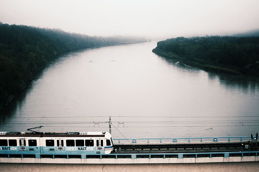 white train on bridge over river during daytime, white train on railings above body of water HD wallpaper