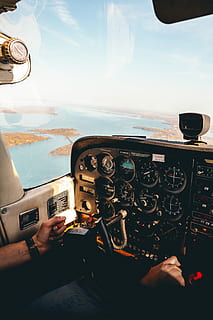 person taking photo inside aircraft, person riding plane sitting on cockpit at daytime HD wallpaper
