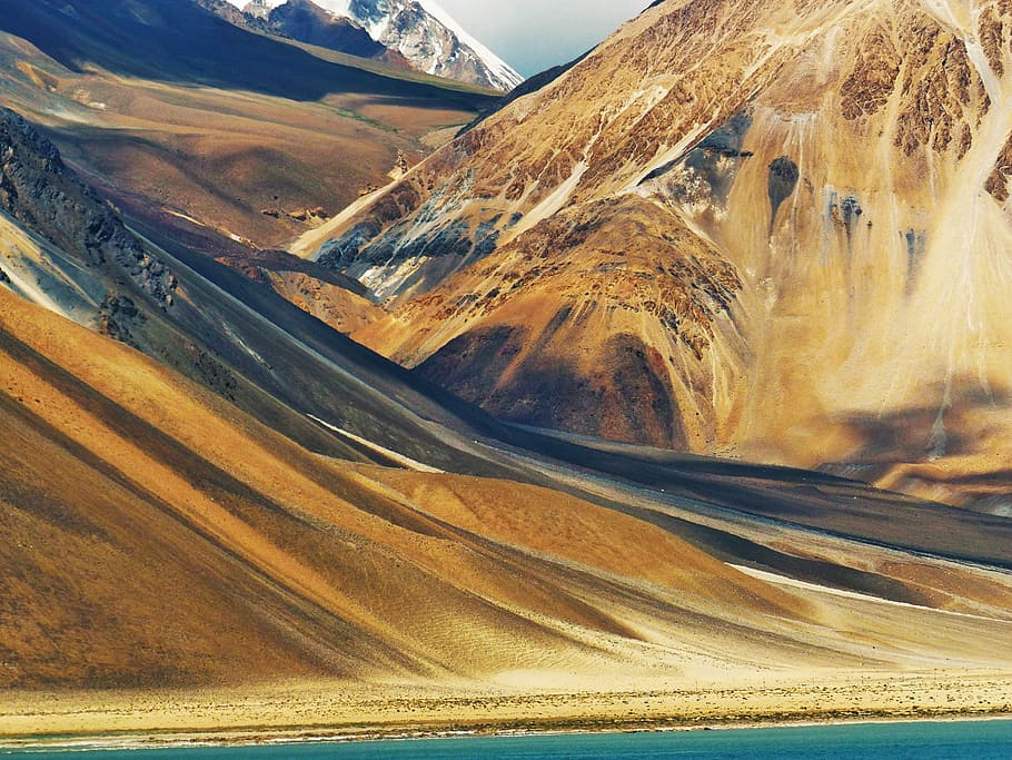 landscape photography of brown mountain, mountain range near body of water HD wallpaper