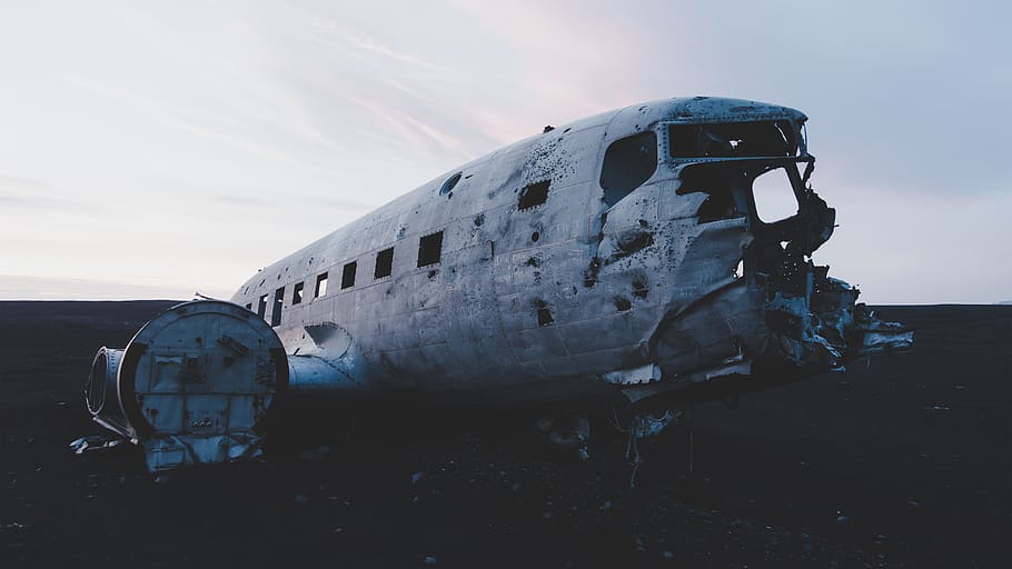 abandoned airplane on the floor under white clouds, crashed airplane on field during daytime