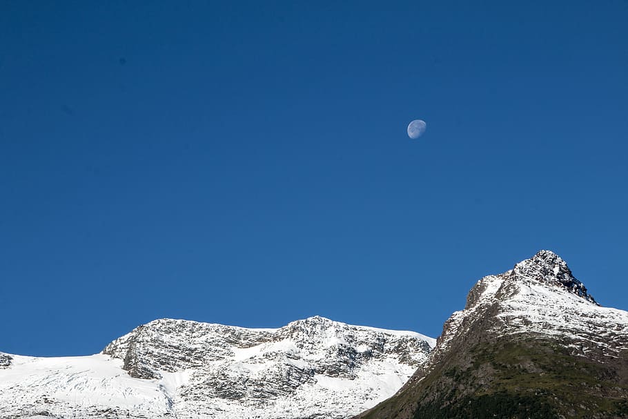 long angle photography of mountain range, moon above mountain during daytime HD wallpaper
