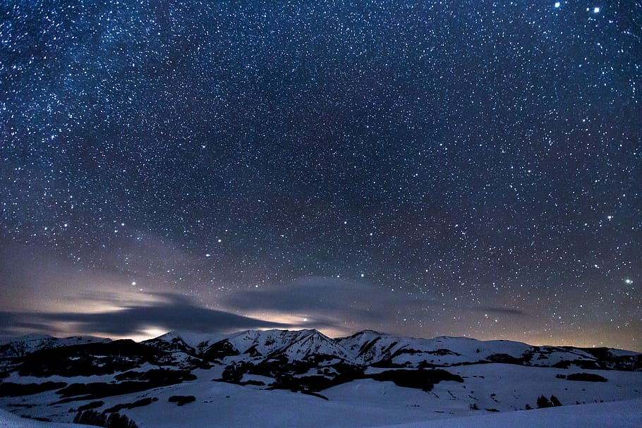 night sky with stars above snow landscape, landscape photo of mountain covered by snow during nighttime