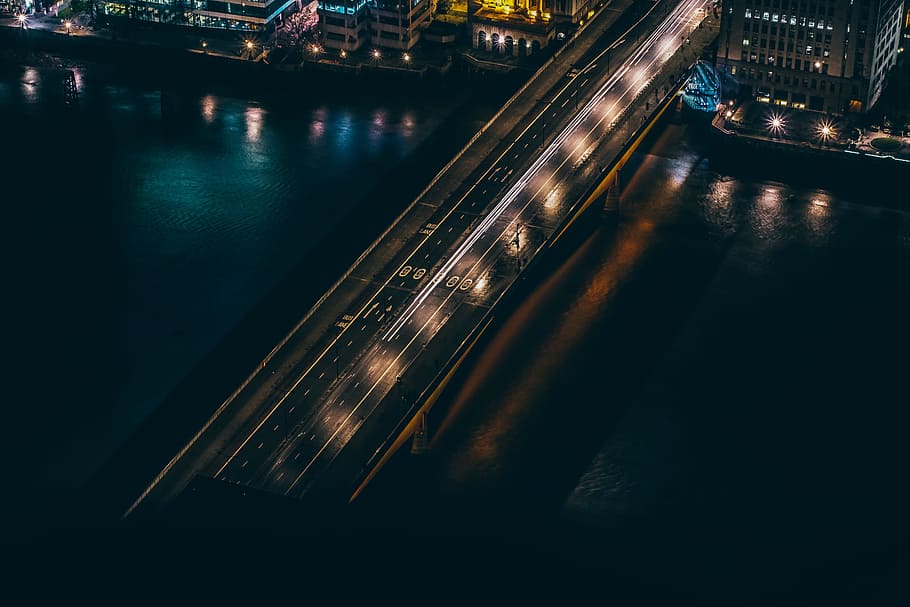 aerial view of building beside bridge, aerial photography of bridge during night time HD wallpaper