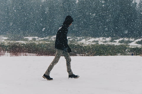 man in black hoodie walking on snow covered field, person, wearing HD wallpaper