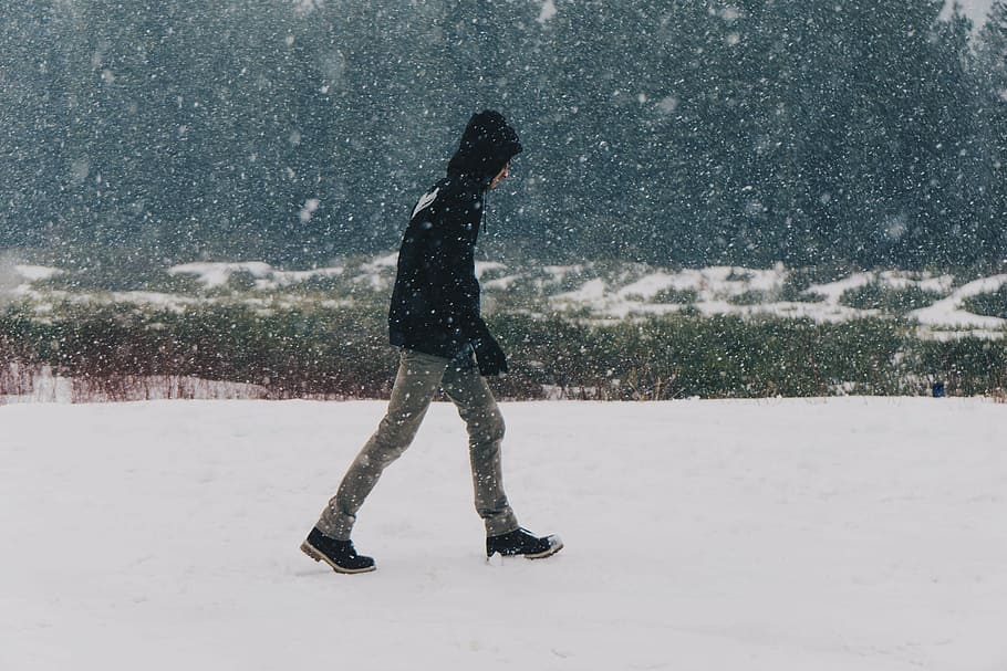 man in black hoodie walking on snow covered field, person, wearing HD wallpaper