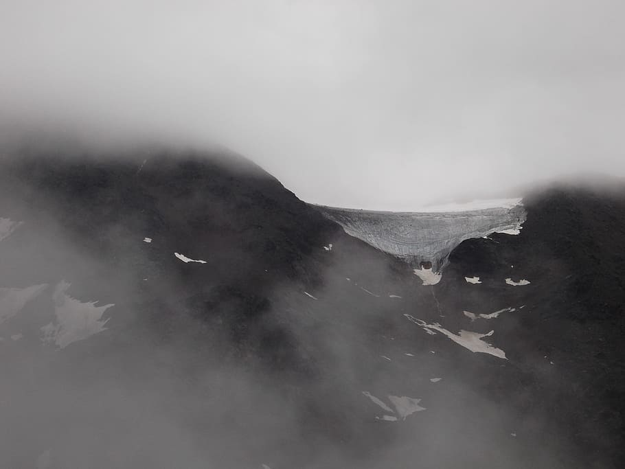 black mountain covered with smokes, black mountain filled with snow and fog HD wallpaper