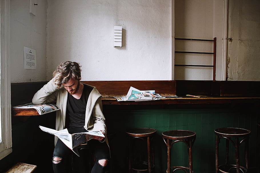 man leaning on desk while reading newspaper, thinking, people HD wallpaper